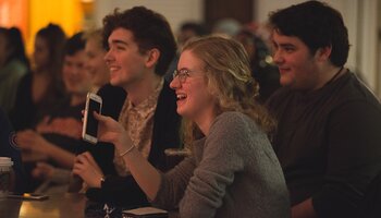 students laughing during Friday Funnies at the Courtyard Café