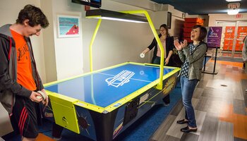 students playing air hockey in the Illini Union Rec Room